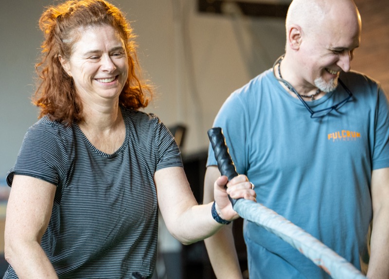 Coach and member during battle ropes training at Fulcrum Fitness
